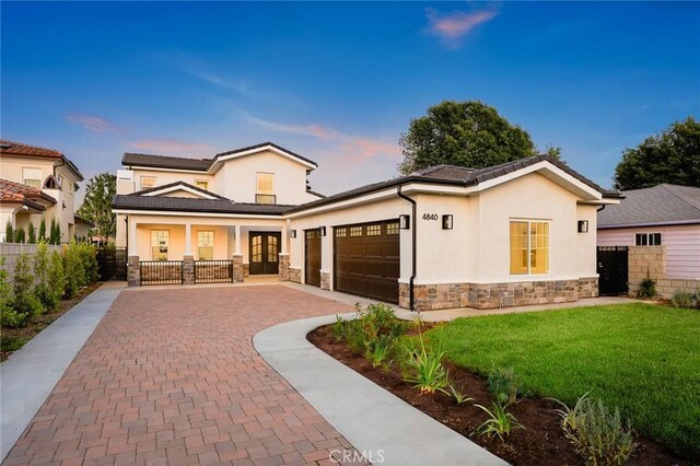 4840 Temple City Blvd, Temple City, CA 91780 - view of front of property featuring stone siding, french doors, a garage, and stucco siding
