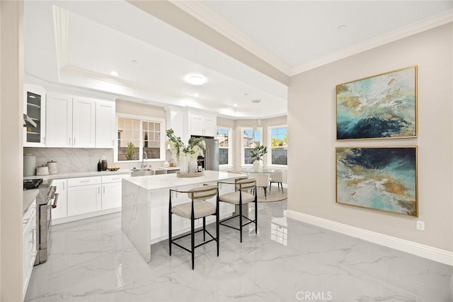 4840 Temple City Blvd, Temple City, CA 91780 - kitchen featuring high end range, a raised ceiling, crown molding, a breakfast bar, and a sink