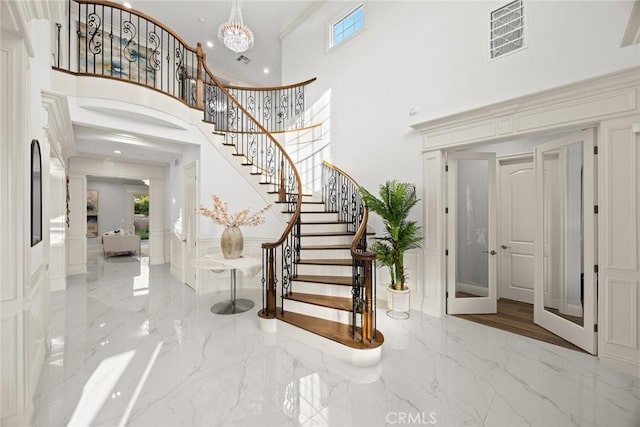 4840 Temple City Blvd, Temple City, CA 91780 - foyer entrance featuring marble tiled flooring, a towering ceiling, stairway, a chandelier, and a decorative wall