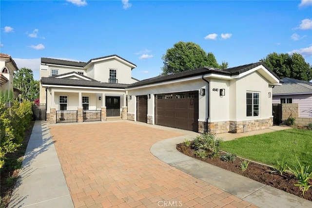 4840 Temple City Blvd, Temple City, CA 91780 - view of front of house featuring stone siding, stucco siding, an attached garage, decorative driveway, and a porch