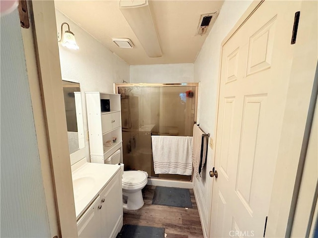 631 N St, Corning, CA 96021 - full bathroom with vanity, a shower stall, wood finished floors, and toilet