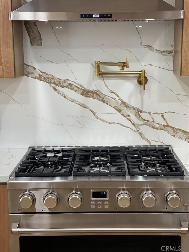 3273 Tilden Ave, Los Angeles, CA 90034 - kitchen view of pot filler, gas range, brown cabinets, and tasteful backsplash