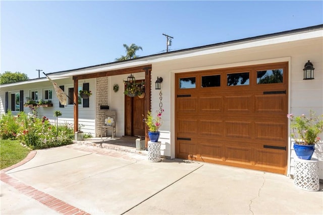 6903 E Driscoll St, Long Beach, CA 90815 - view of front of house with driveway, a porch, and an attached garage