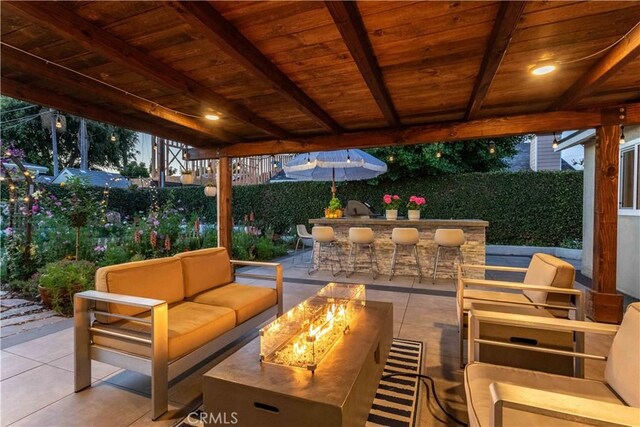 6903 E Driscoll St, Long Beach, CA 90815 - fenced backyard featuring an outdoor living space with a fire pit and a patio