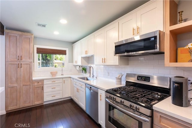 6903 E Driscoll St, Long Beach, CA 90815 - kitchen featuring appliances with stainless steel finishes, a sink, light countertops, dark wood finished floors, and recessed lighting