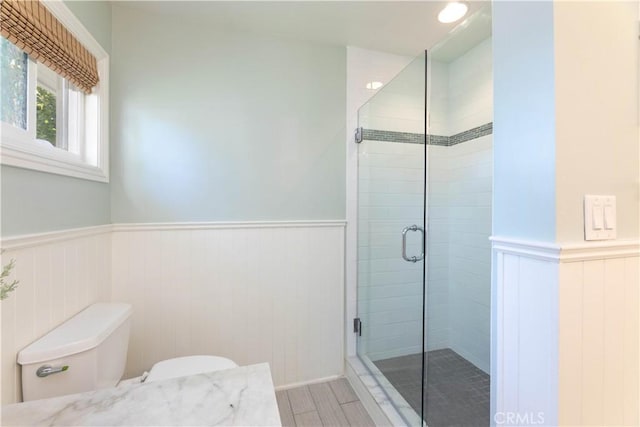 6903 E Driscoll St, Long Beach, CA 90815 - full bathroom featuring wainscoting, a shower stall, and toilet