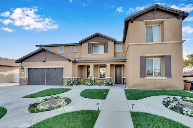 4777 Magnum Way, Jurupa Valley, CA 91752 - view of front of home with stucco siding, driveway, a garage, a porch, and stone siding