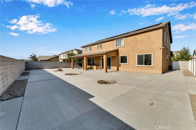 4777 Magnum Way, Jurupa Valley, CA 91752 - back of property with a fenced backyard, a patio area, stucco siding, and a fire pit
