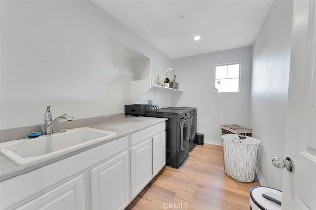 4777 Magnum Way, Jurupa Valley, CA 91752 - laundry area featuring washing machine and dryer, light wood-style floors, baseboards, recessed lighting, and cabinet space