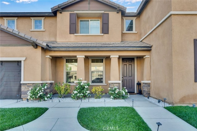 4777 Magnum Way, Jurupa Valley, CA 91752 - property entrance featuring covered porch, stone siding, and stucco siding
