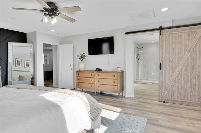 4777 Magnum Way, Jurupa Valley, CA 91752 - bedroom with a barn door, light wood-style floors, recessed lighting, ensuite bathroom, and ceiling fan