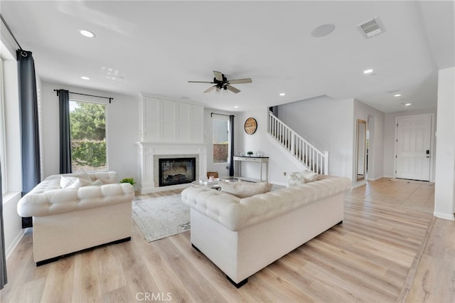 4777 Magnum Way, Jurupa Valley, CA 91752 - living room with stairs, recessed lighting, light wood finished floors, a ceiling fan, and a large fireplace