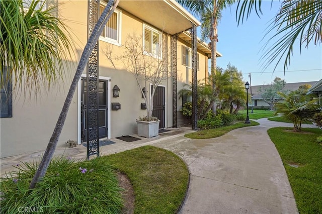 1741 Tustin Ave Unit 2A, Costa Mesa, CA 92627 - property entrance with stucco siding and a yard