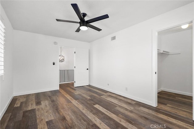 1741 Tustin Ave Unit 2A, Costa Mesa, CA 92627 - unfurnished bedroom featuring dark wood-style flooring, a walk in closet, a closet, and a ceiling fan