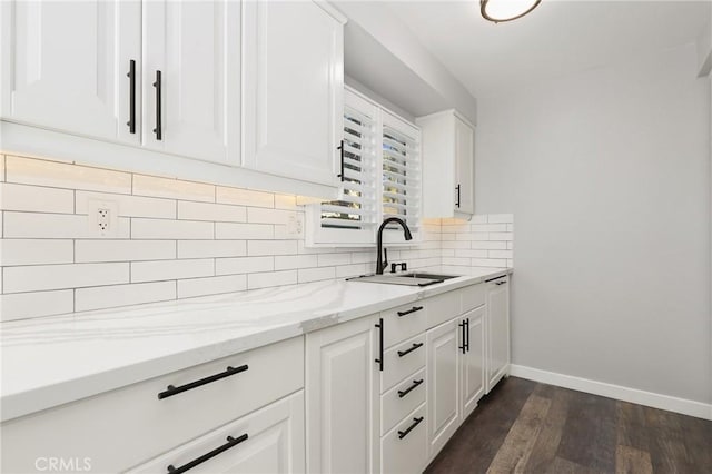 1741 Tustin Ave Unit 2A, Costa Mesa, CA 92627 - kitchen featuring dark wood-style flooring, decorative backsplash, white cabinets, light stone countertops, and dishwasher