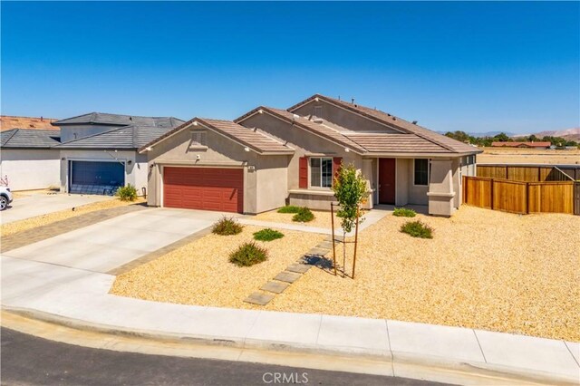 3615 Santa Monica Ct, Rosamond, CA 93560 - single story home featuring stucco siding, an attached garage, driveway, and a tile roof