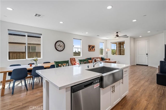 3615 Santa Monica Ct, Rosamond, CA 93560 - kitchen featuring stainless steel dishwasher, open floor plan, recessed lighting, wood finished floors, and white cabinetry