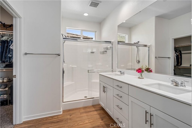 3615 Santa Monica Ct, Rosamond, CA 93560 - full bath featuring a spacious closet, double vanity, a shower stall, wood finished floors, and recessed lighting