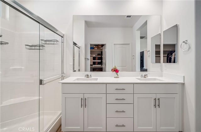 3615 Santa Monica Ct, Rosamond, CA 93560 - bathroom with tiled shower, a walk in closet, and double vanity