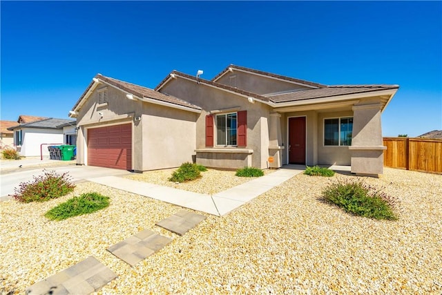 3615 Santa Monica Ct, Rosamond, CA 93560 - ranch-style house with stucco siding, an attached garage, and driveway