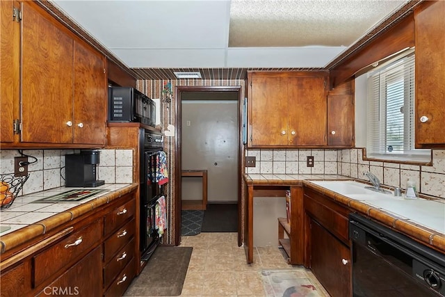 1255 E 25th St, San Bernardino, CA 92404 - kitchen featuring black appliances, tile counters, tasteful backsplash, and a sink