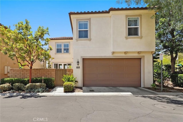 410 N Tapia Ln, Brea, CA 92821 - mediterranean / spanish home with stucco siding, an attached garage, and a tile roof