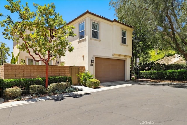 410 N Tapia Ln, Brea, CA 92821 - view of front of house featuring stucco siding, a garage, and driveway