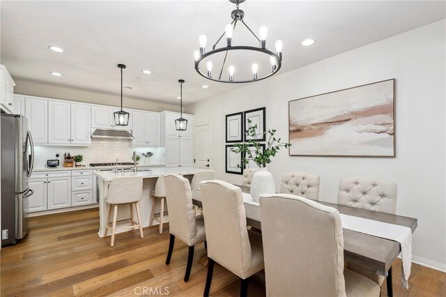 410 N Tapia Ln, Brea, CA 92821 - dining space with light wood finished floors, a chandelier, recessed lighting, and baseboards