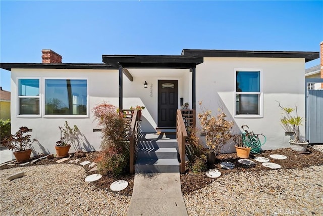 3549 S Cochran Ave, Los Angeles, CA 90016 - view of front facade featuring stucco siding and a chimney