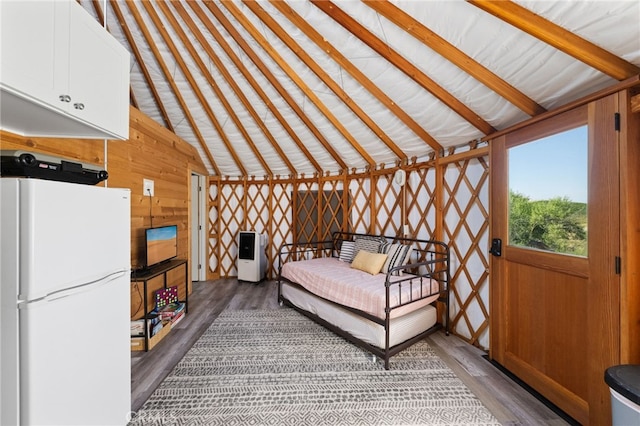 32955 Buckskin Rd, Temecula, CA 92592 - bedroom featuring freestanding refrigerator, wood finished floors, wood walls, and lofted ceiling