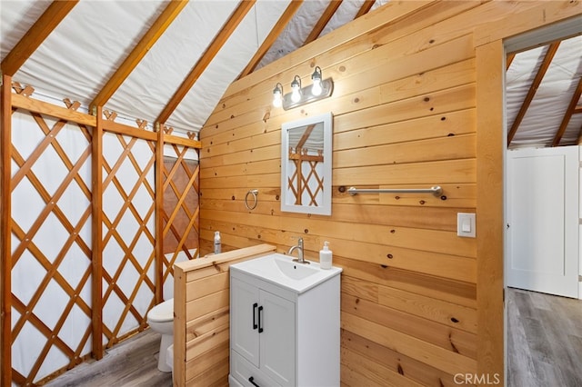 32955 Buckskin Rd, Temecula, CA 92592 - bathroom with vanity, toilet, wood finished floors, wood walls, and lofted ceiling