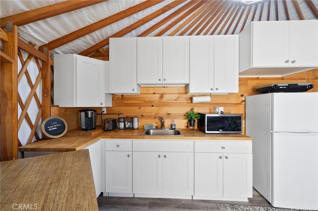 32955 Buckskin Rd, Temecula, CA 92592 - kitchen with freestanding refrigerator, a sink, white cabinetry, wood finished floors, and lofted ceiling
