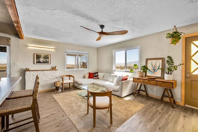 68365 Emerald Dr Unit 29, Palms, CA 92277 - living area featuring ceiling fan, healthy amount of natural light, a textured ceiling, and wood finished floors
