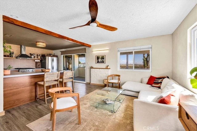 68365 Emerald Dr Unit 29, Palms, CA 92277 - living room with wood finished floors, a textured ceiling, and a ceiling fan