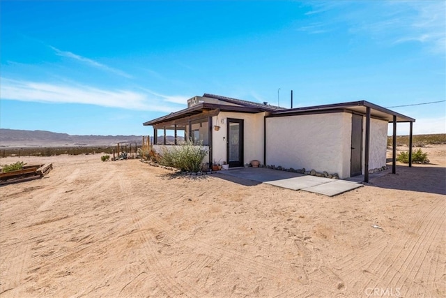 68365 Emerald Dr Unit 29, Palms, CA 92277 - view of front of house featuring stucco siding and a mountain view