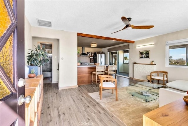 68365 Emerald Dr Unit 29, Palms, CA 92277 - living room featuring light wood-style flooring, a ceiling fan, a textured ceiling, and baseboards