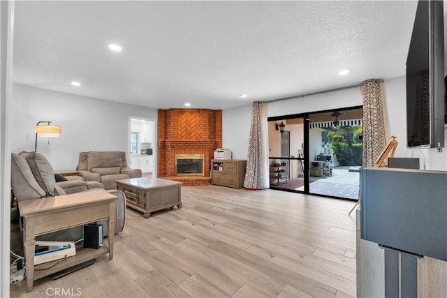 1931 El Sereno Ave, Arcadia, CA 91007 - living room featuring light wood-style floors, a fireplace, recessed lighting, and a textured ceiling