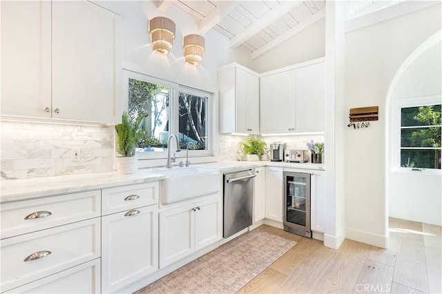 802 Rembrandt Dr, Laguna Beach, CA 92651 - kitchen with beverage cooler, a sink, stainless steel dishwasher, backsplash, and white cabinets