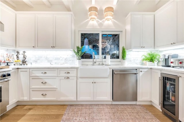 802 Rembrandt Dr, Laguna Beach, CA 92651 - kitchen featuring dishwasher, wine cooler, a sink, white cabinets, and beam ceiling