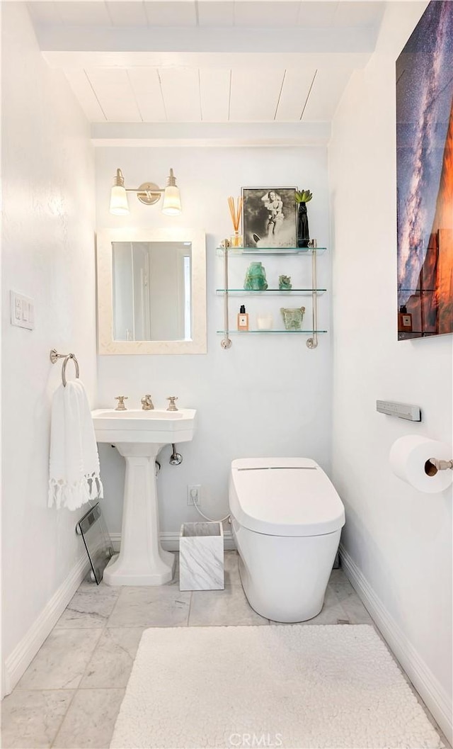 802 Rembrandt Dr, Laguna Beach, CA 92651 - bathroom with beam ceiling, baseboards, and toilet