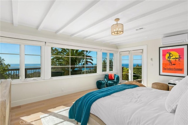 802 Rembrandt Dr, Laguna Beach, CA 92651 - bedroom featuring a wall mounted AC, beam ceiling, wood finished floors, access to outside, and baseboards