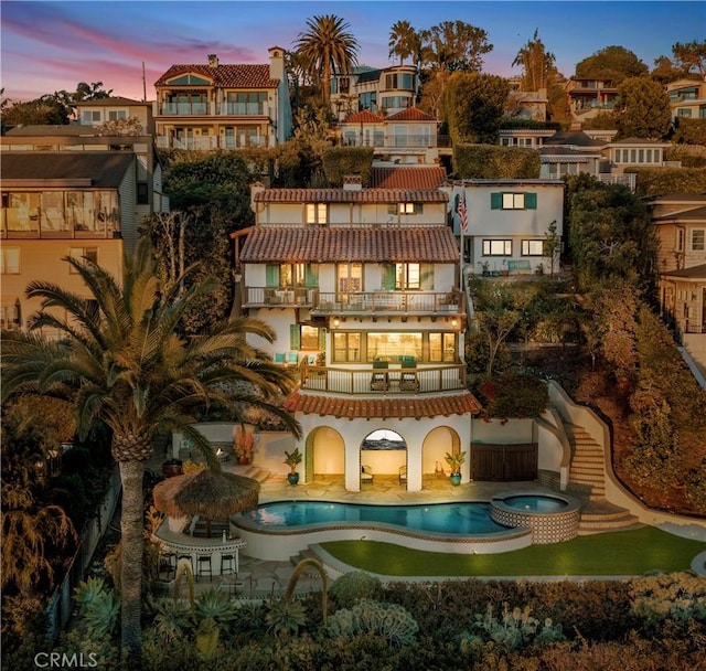 802 Rembrandt Dr, Laguna Beach, CA 92651 - back of property featuring a balcony, a pool with connected hot tub, a patio, and stucco siding