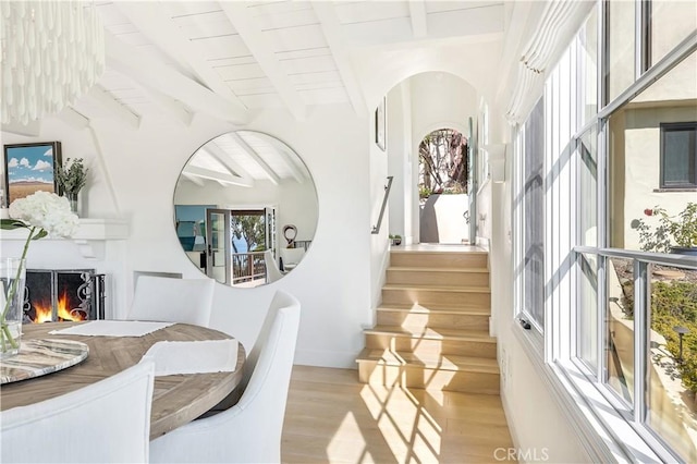 802 Rembrandt Dr, Laguna Beach, CA 92651 - dining area featuring plenty of natural light, light wood finished floors, beam ceiling, and a large fireplace