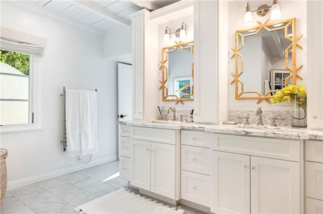 802 Rembrandt Dr, Laguna Beach, CA 92651 - bathroom with marble look tile flooring, double vanity, beam ceiling, baseboards, and backsplash