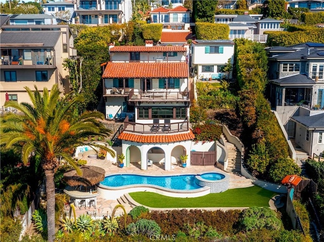 802 Rembrandt Dr, Laguna Beach, CA 92651 - rear view of house featuring a balcony, a residential view, a patio, a tiled roof, and a pool with connected hot tub