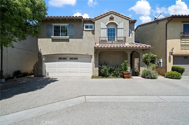 16741 Tim Ln, Van Nuys, CA 91406 - view of front of home featuring a tile roof, stucco siding, asphalt driveway, and a garage