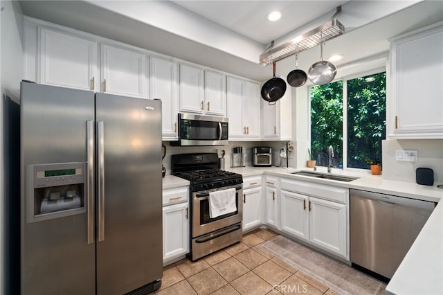 16741 Tim Ln, Van Nuys, CA 91406 - kitchen with stainless steel appliances, a sink, white cabinets, light countertops, and recessed lighting