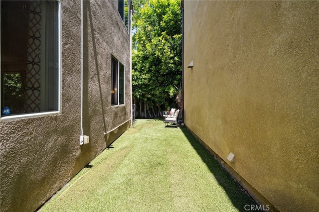 16741 Tim Ln, Van Nuys, CA 91406 - view of home's exterior featuring stucco siding and a yard