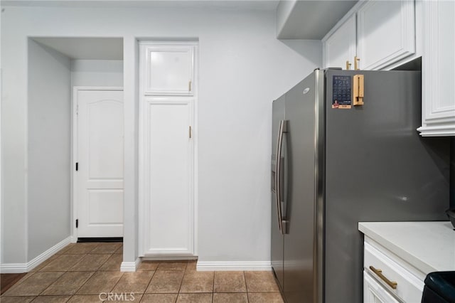 16741 Tim Ln, Van Nuys, CA 91406 - kitchen featuring stainless steel fridge with ice dispenser, white cabinetry, baseboards, tile patterned flooring, and light countertops