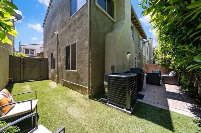16741 Tim Ln, Van Nuys, CA 91406 - view of property exterior featuring a gate, stucco siding, cooling unit, and a patio